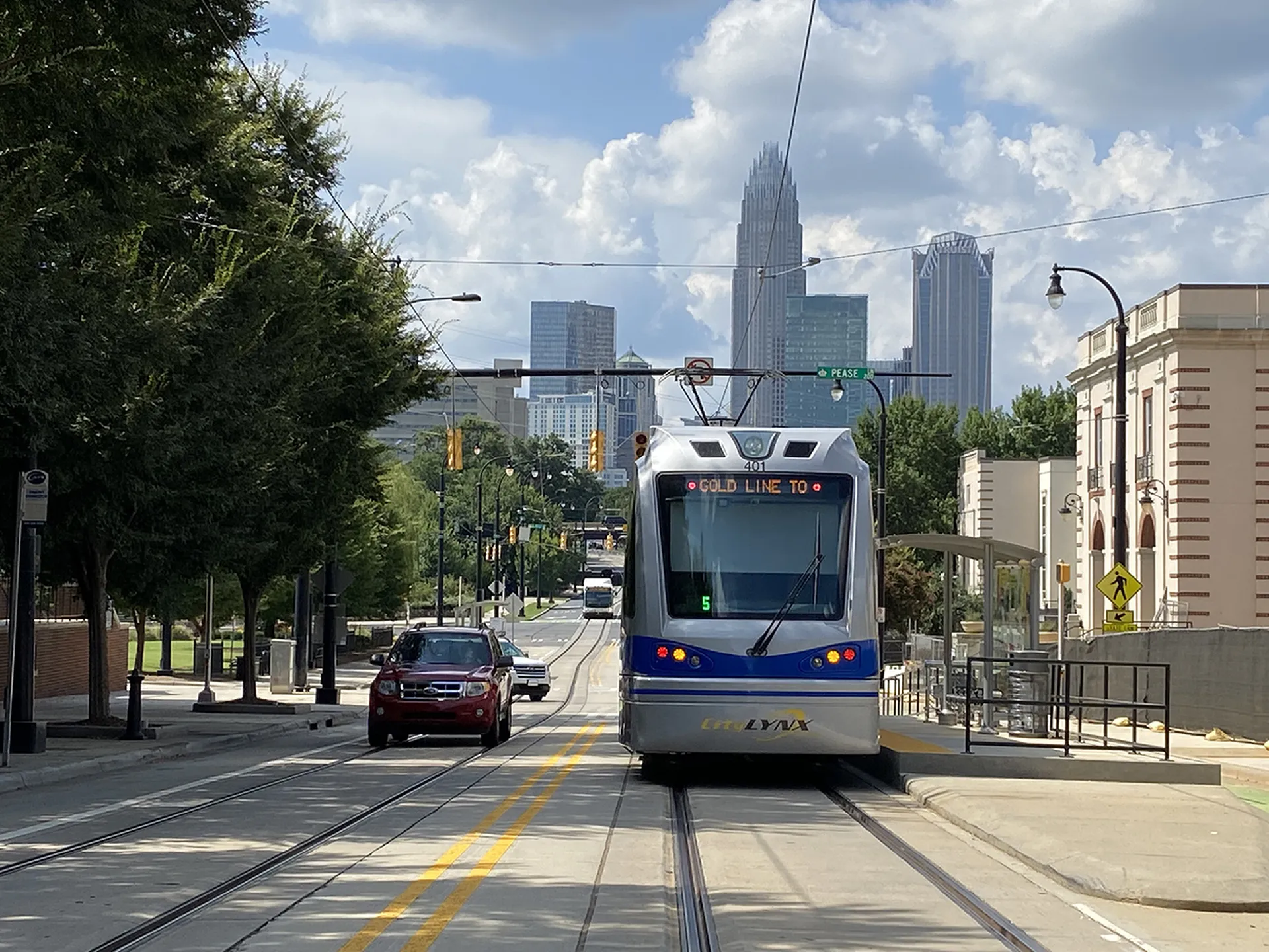 Charlotte LYNX Gold Line streetcar with Uptown skyline